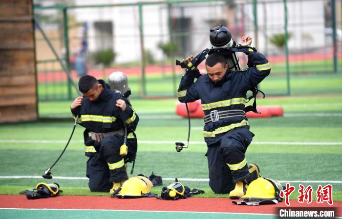 新消防員進(jìn)行穿戴空呼器展示。　劉忠俊 攝